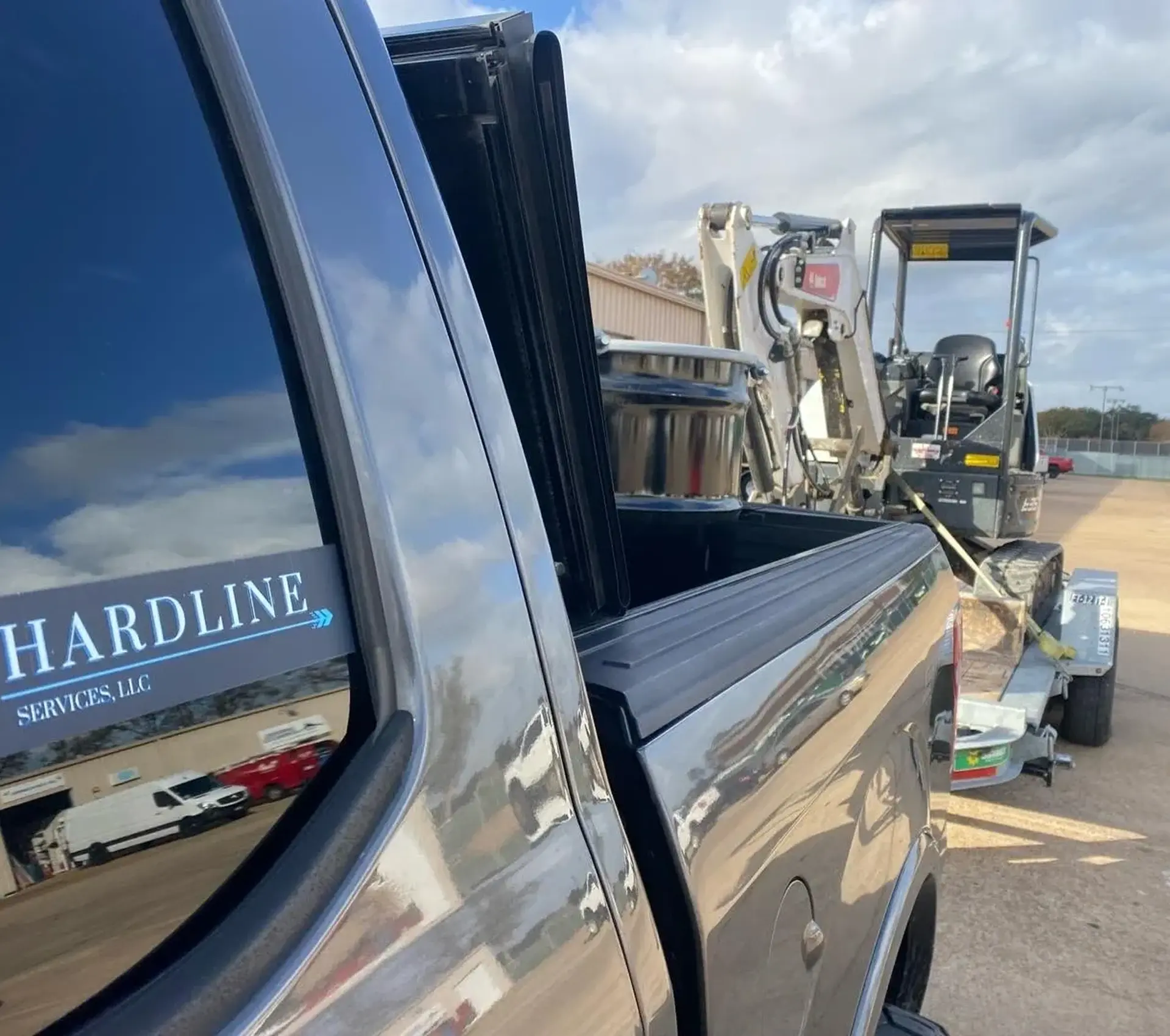 Truck towing small construction excavator