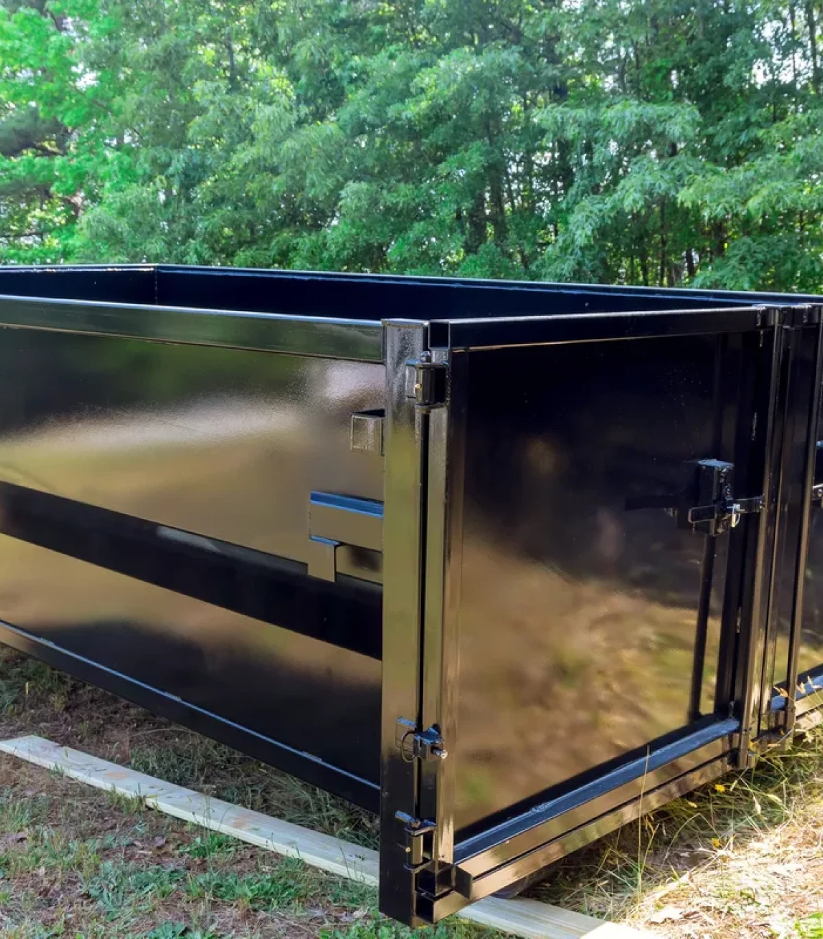Large black container on grass